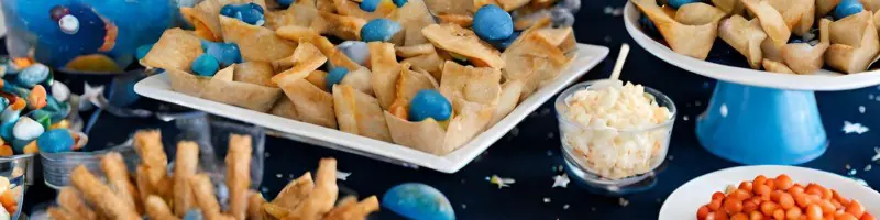 Space themed food on a table cloth with stars on.
